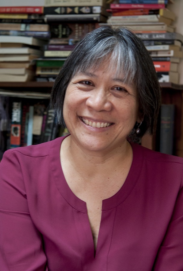 Hedy with books welcoming smile updated small version